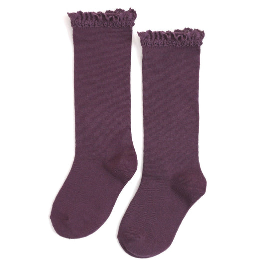 Pair of purple knee-high socks with ruffled top on a white background