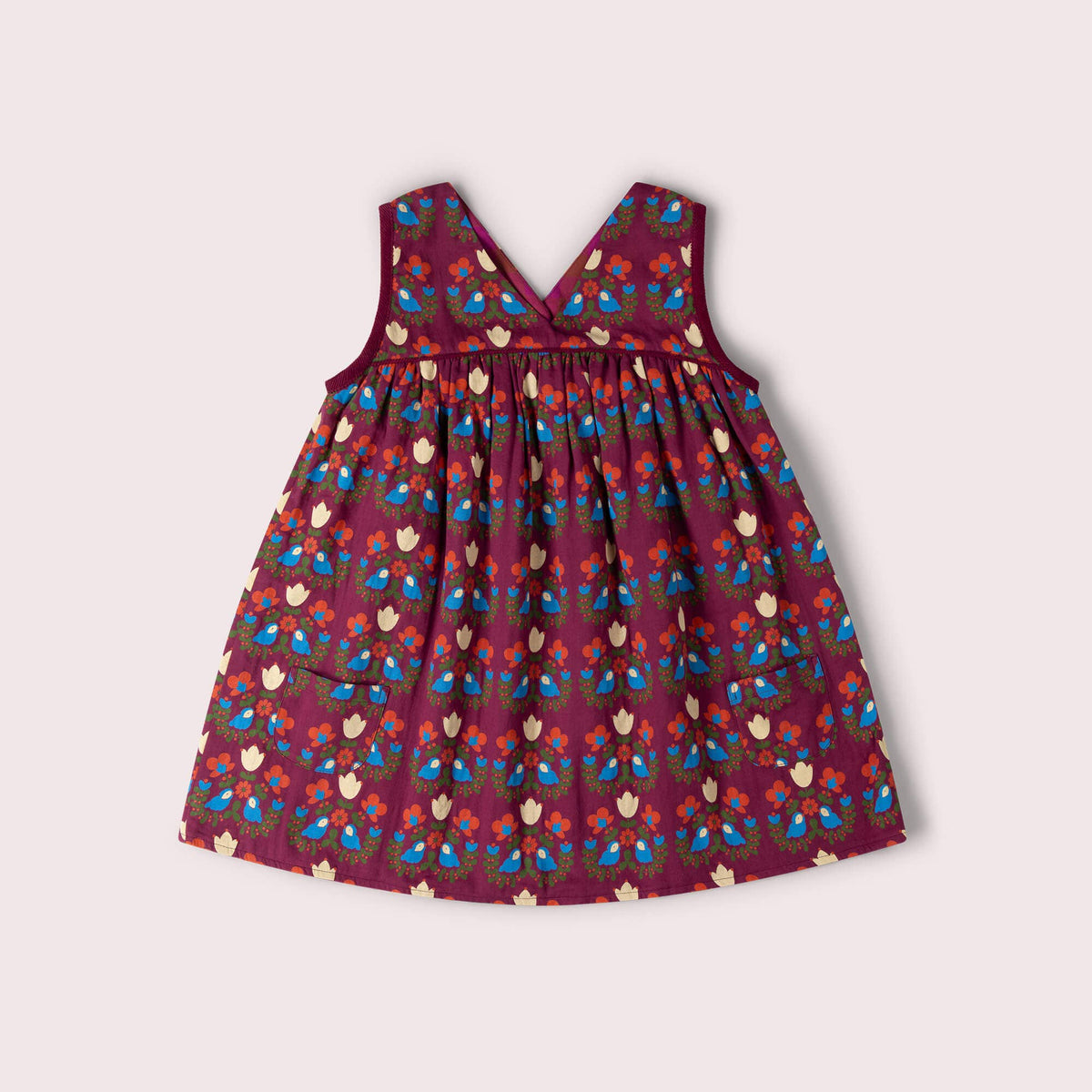 Burgundy sleeveless swing dress with blue birds, colorful flowers and patch pockets.