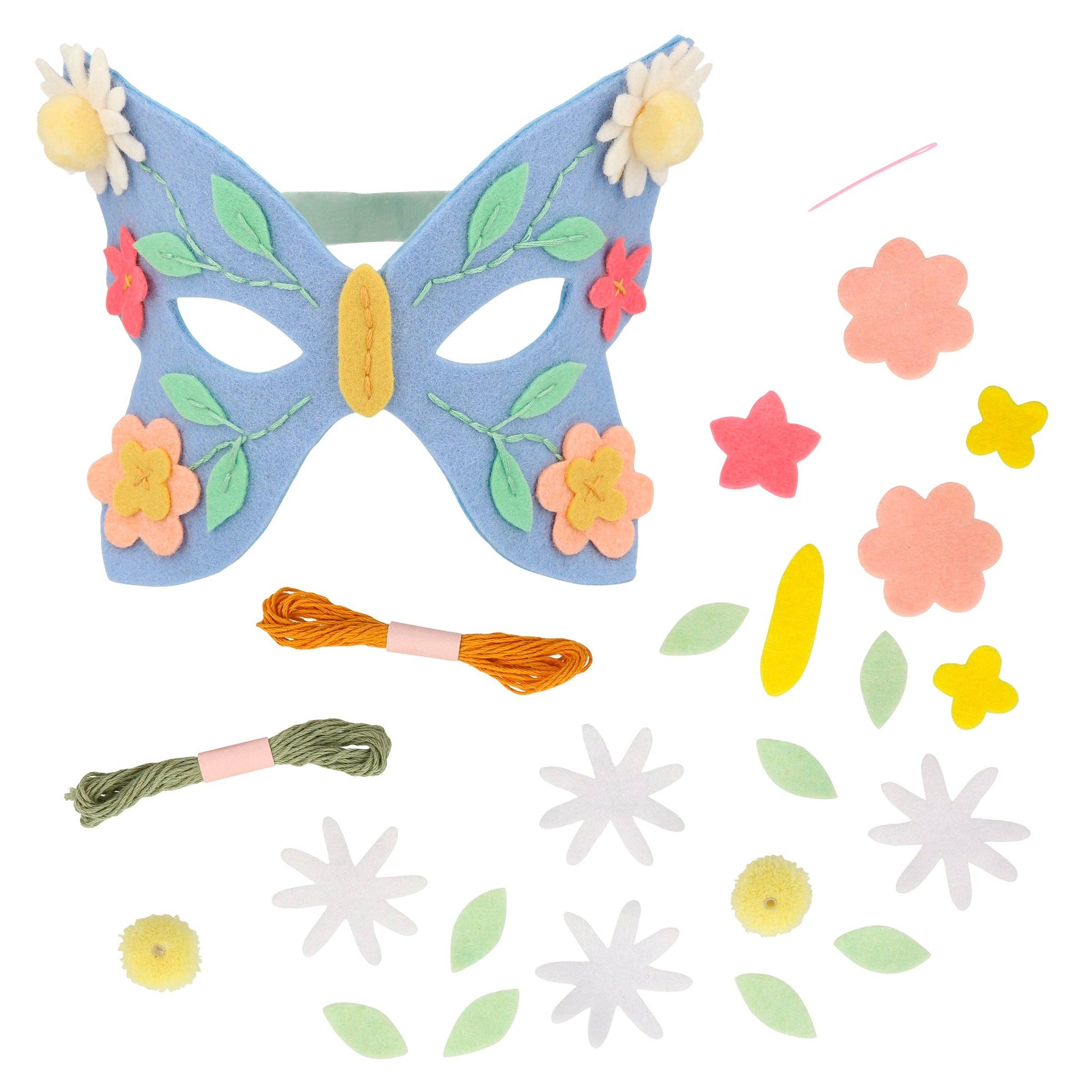 Butterfly mask with floral decorations and craft materials on a white background