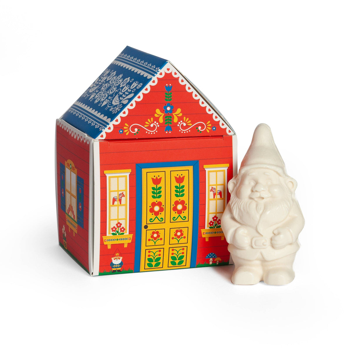 The Gnome's Cottage bar soap shaped like a gnome beside its red Scandinavian cottage gift box