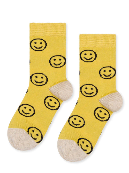 Yellow socks with smiley face pattern on a white background