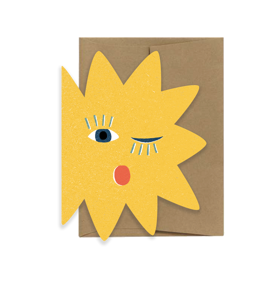 Cutout card with a yellow sun design featuring eyes and a mouth on a brown envelope.