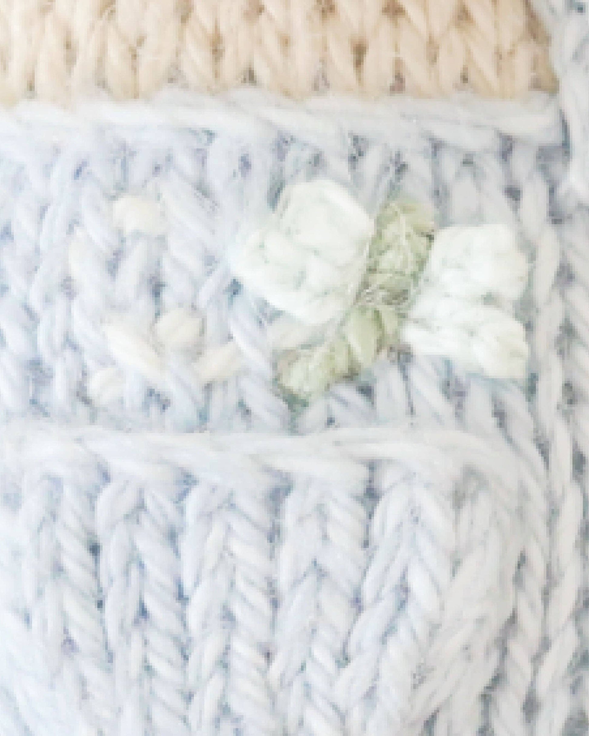 Close-up of knitted fabric with a dragonfly