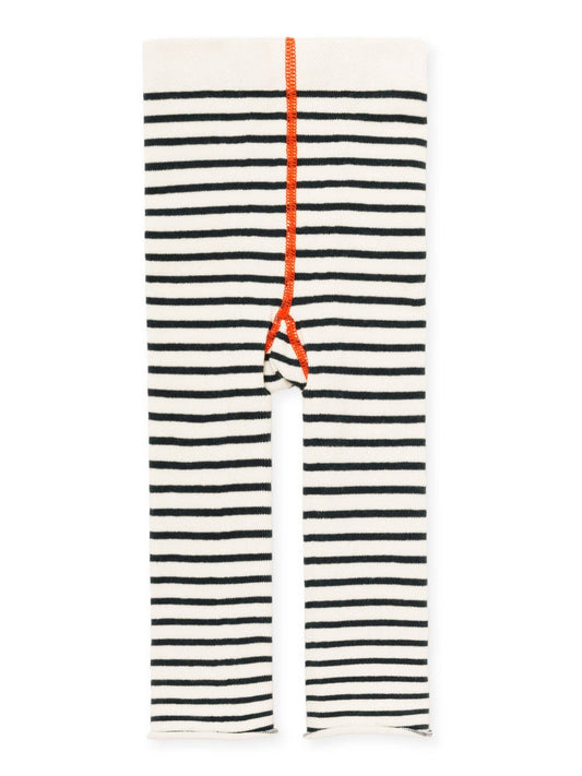 Black and white striped leggings with a orange coral seam on a white background