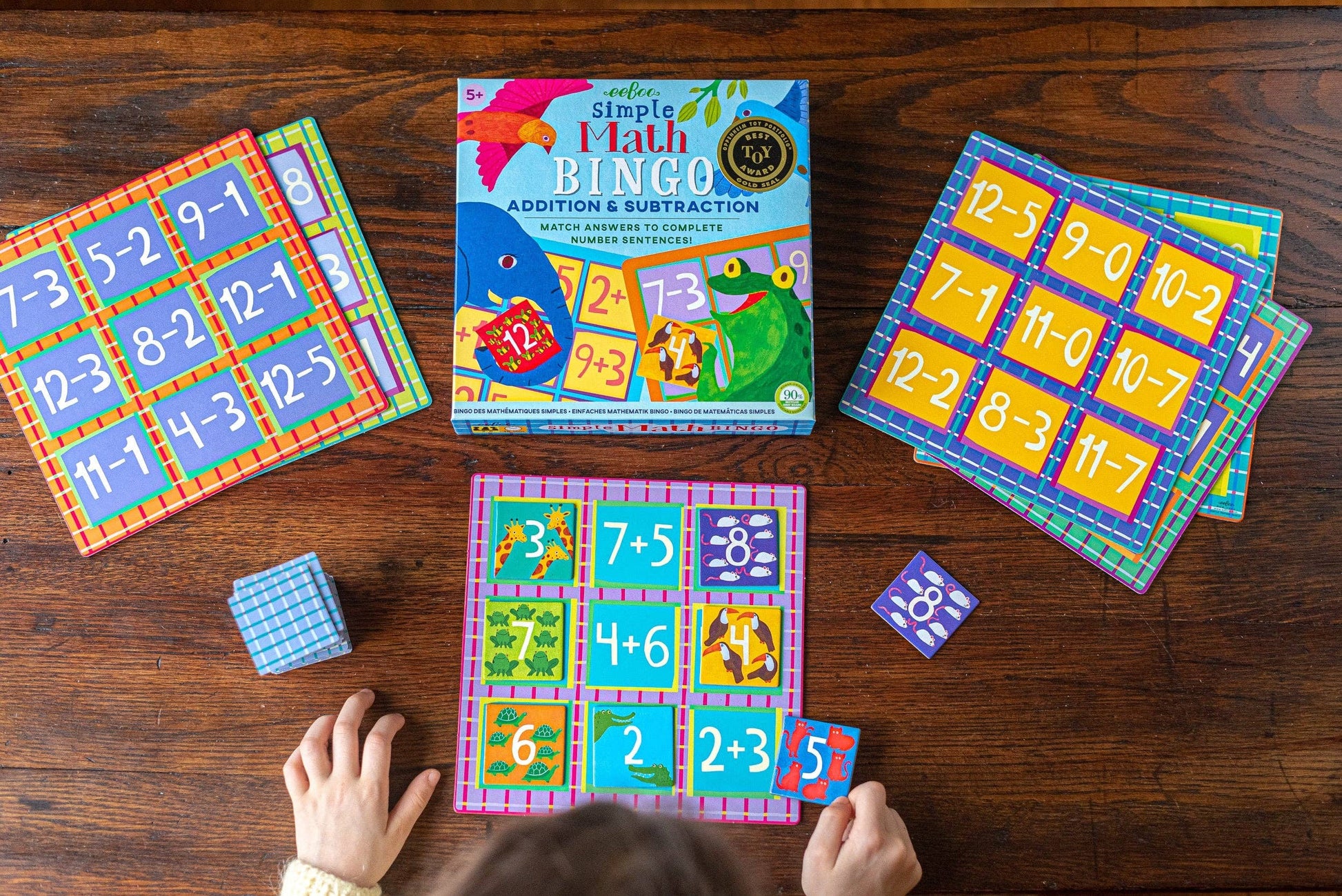 Simple Math Bingo game with colorful cards on a wooden table