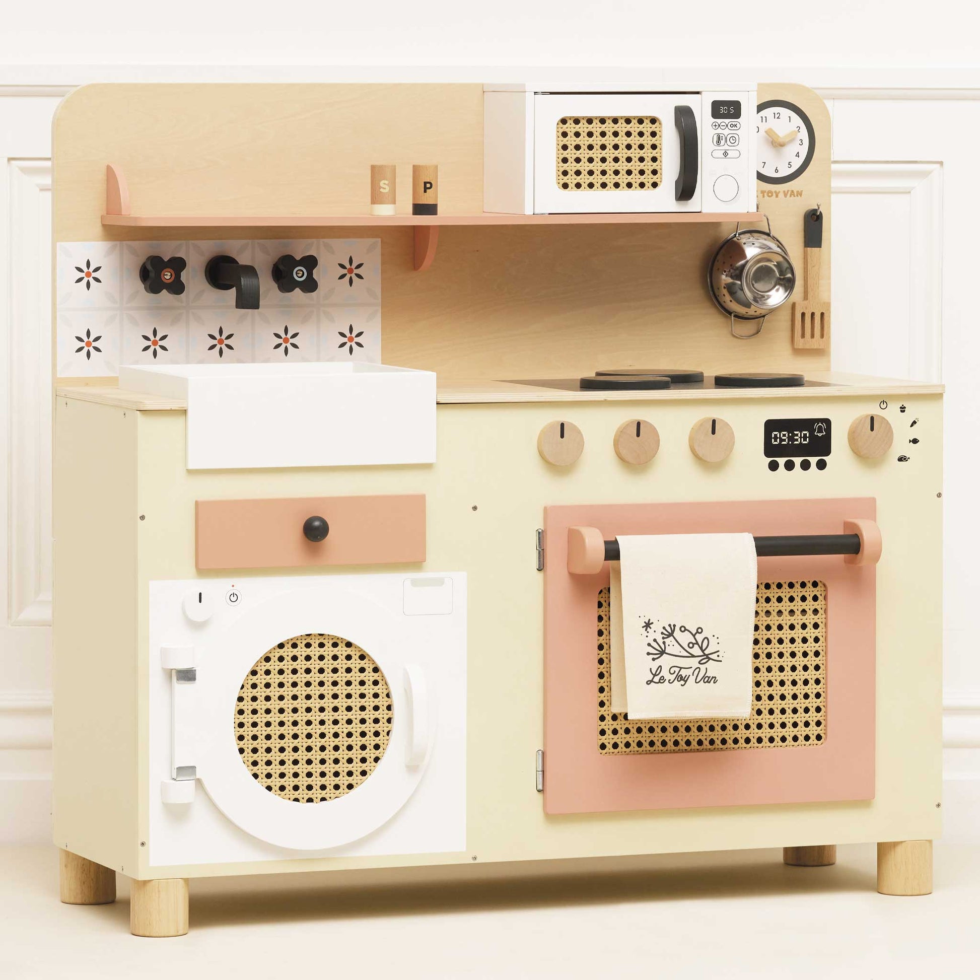Wooden toy kitchen set with beige and pink appliances on a white background