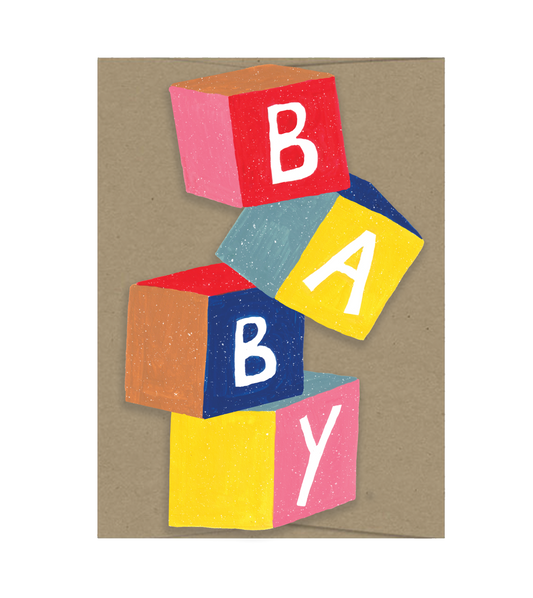 Colorful cutout baby blocks spelling 'BABY' on a brown envelope