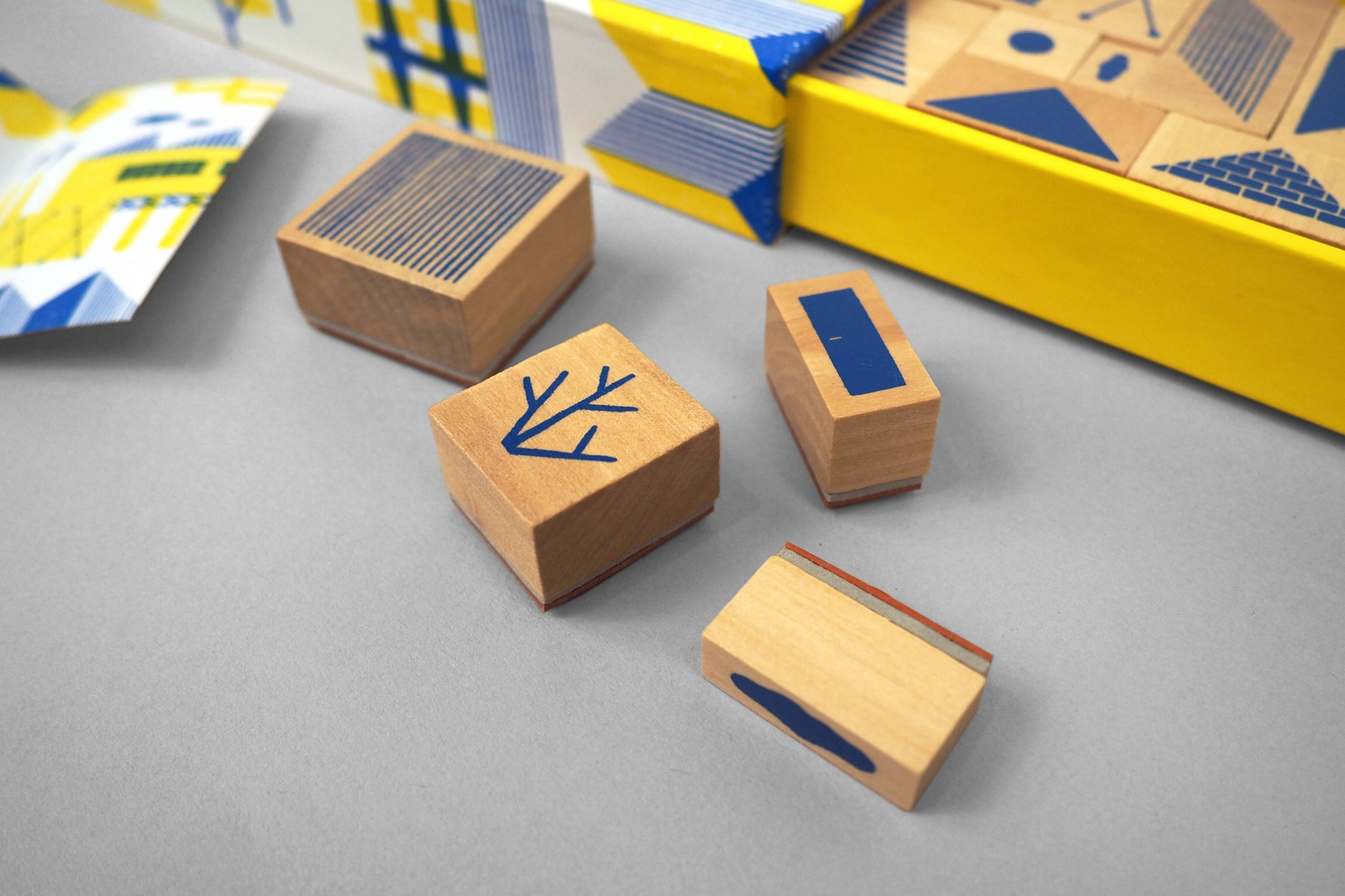 Wooden blocks with blue designs on a gray surface