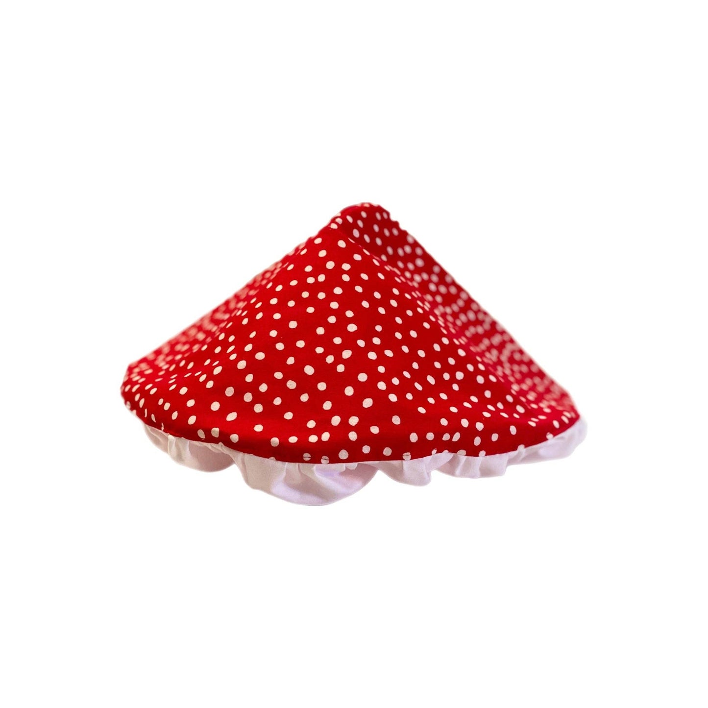Red polka dot mushroom shaped hat with a white edge on a white background