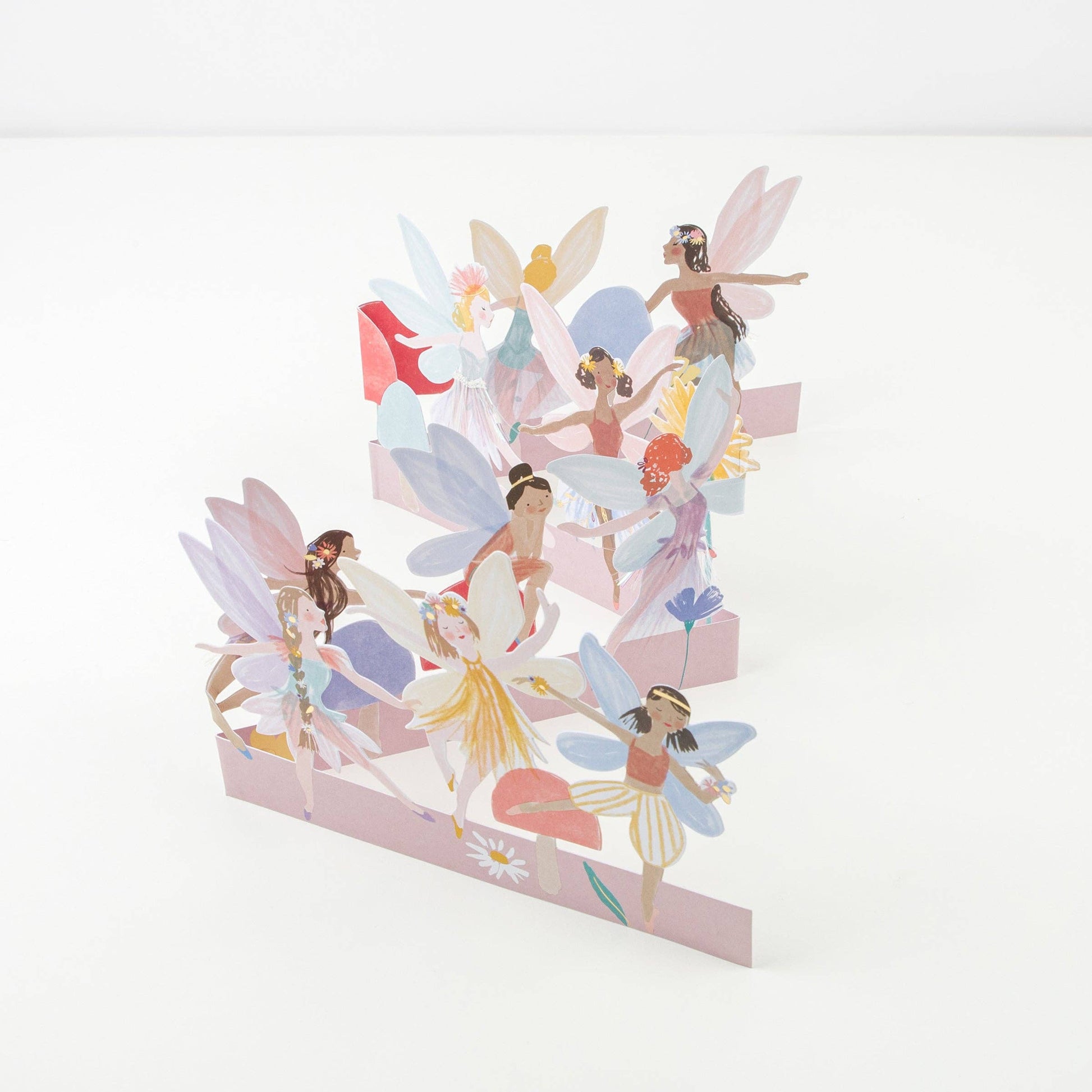 Set of colorful fairy figurines on a white background
