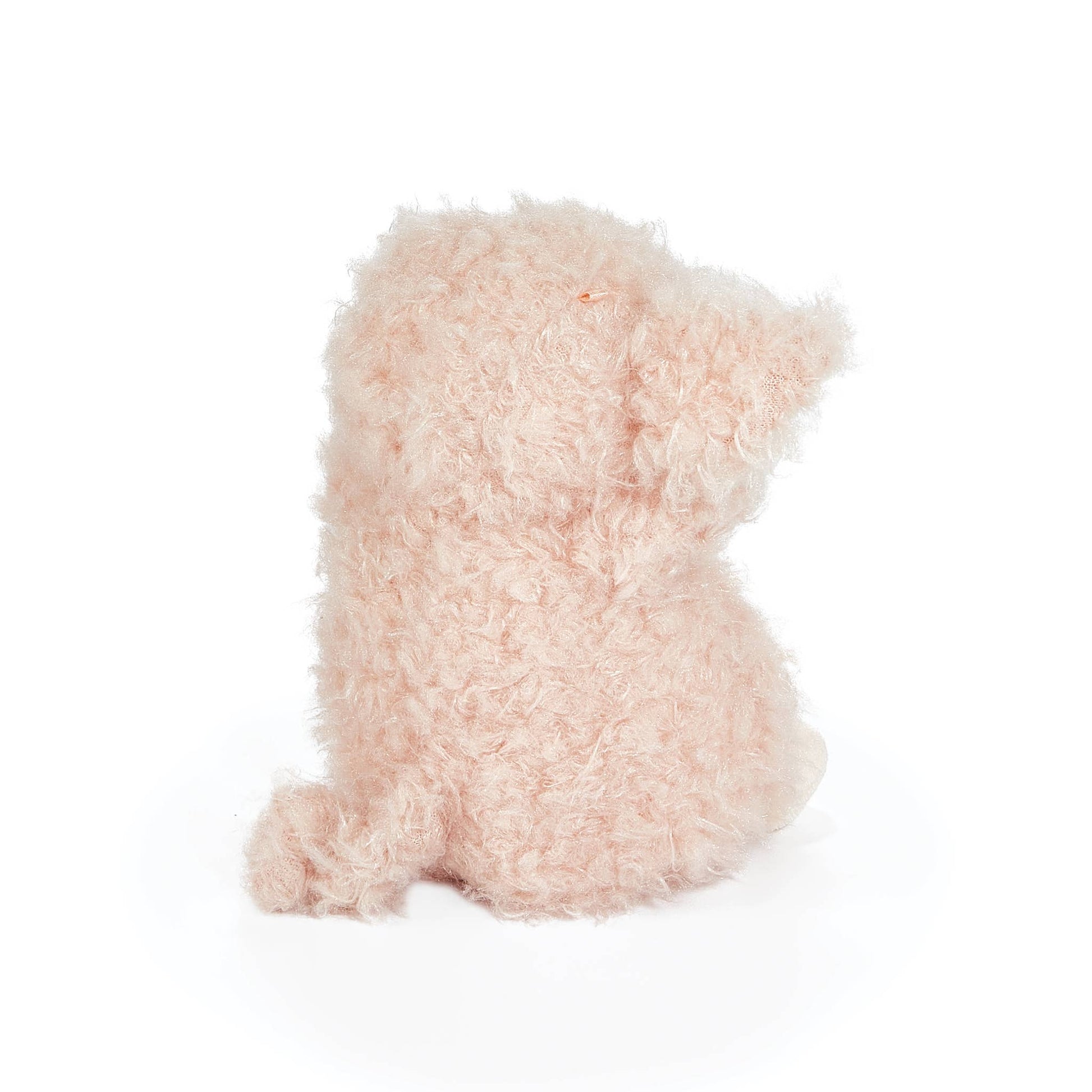 Fluffy pink pig toy on a white background