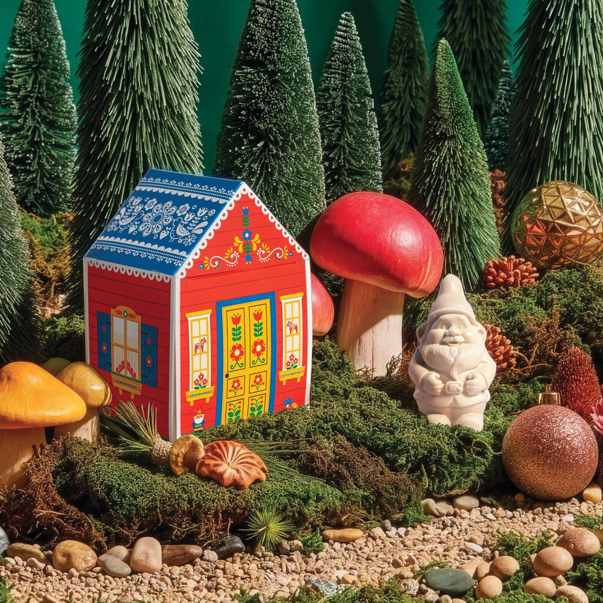 The Gnome's Cottage gift box and gnome soap in a mossy forest scene with mushrooms