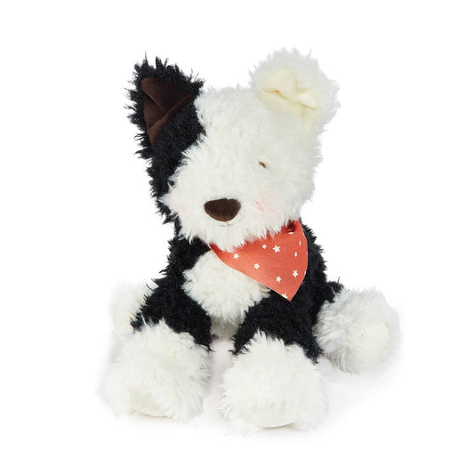 Black and white stuffed dog toy with a red bandana on a white background