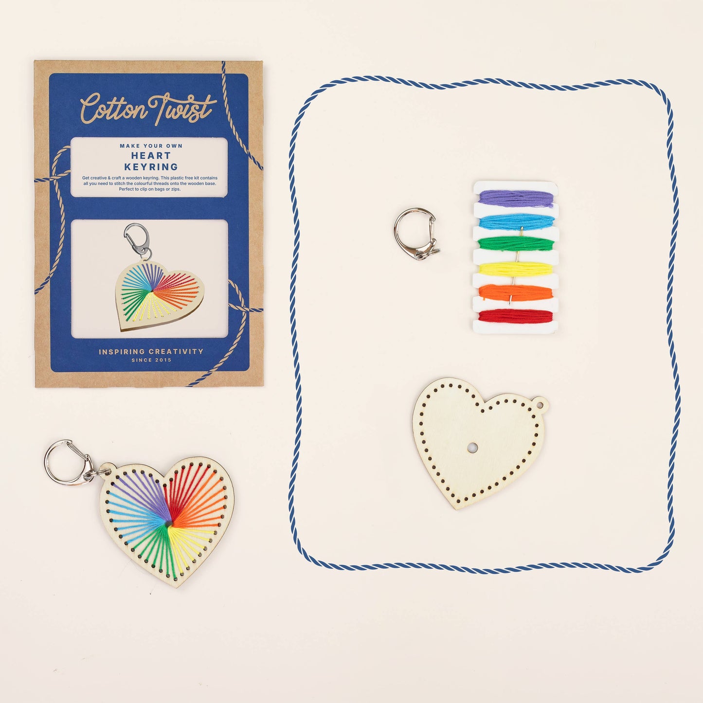 Cotton Twist keyring kit with heart-shaped keychain, packaging, colorful thread, and keyring on a white background