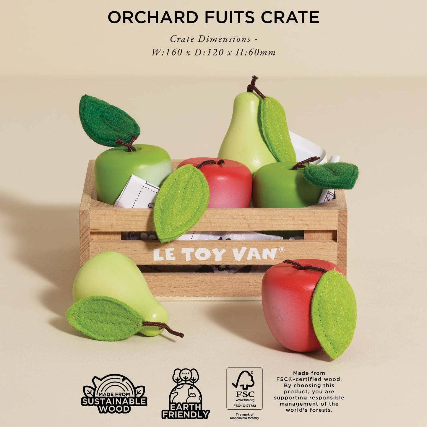 Wooden crate with toy fruits and LE TOY VAN branding on a beige background