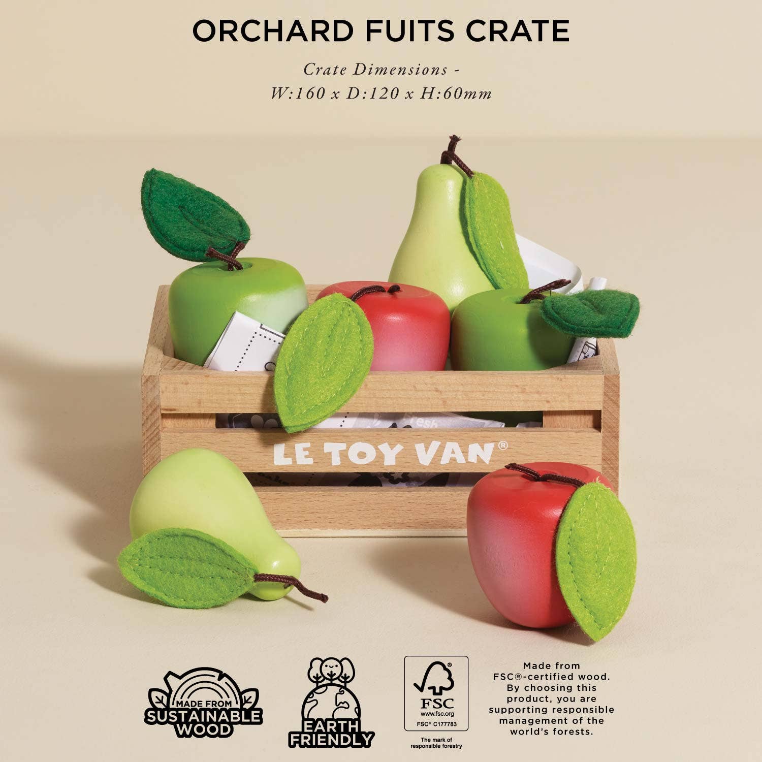 Wooden crate with toy fruits and LE TOY VAN branding on a beige background