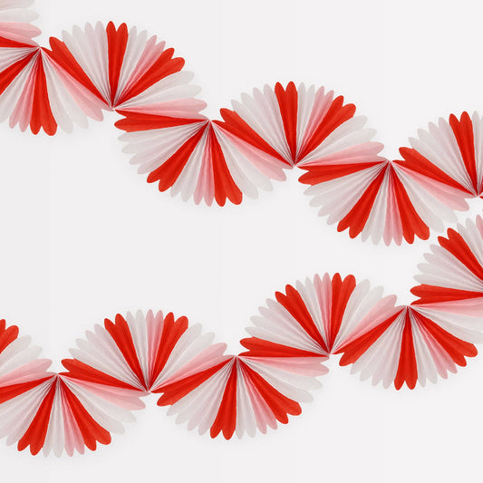 Red and white paper fan decorations arranged in a circular pattern on a white background