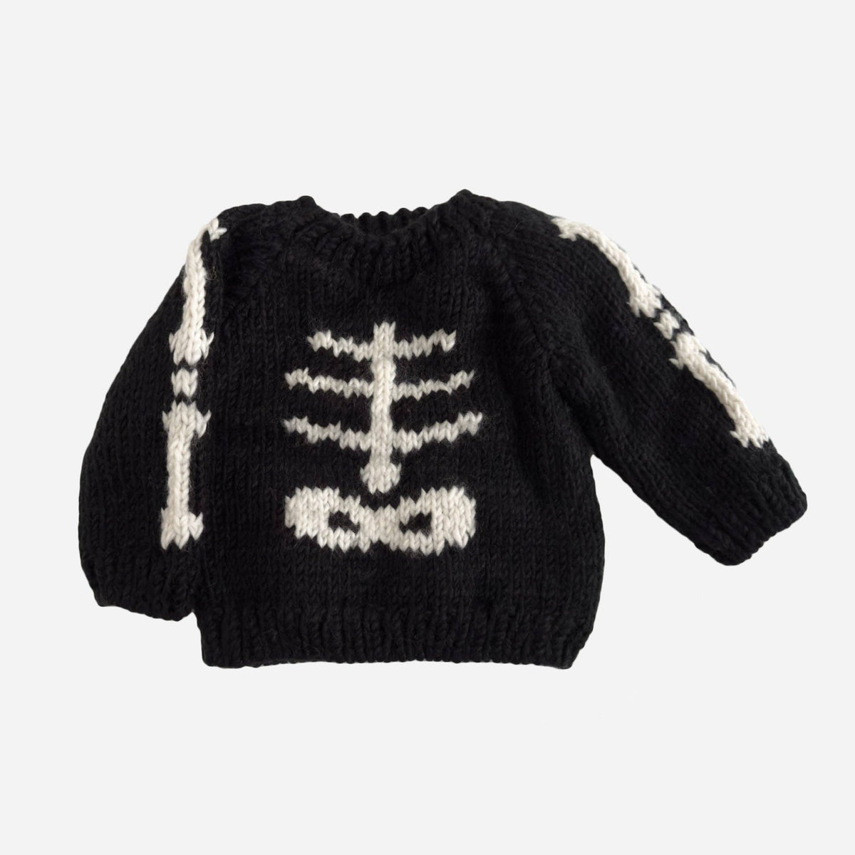 Children's black knitted pullover sweater with skeleton design on it, shown on a white background