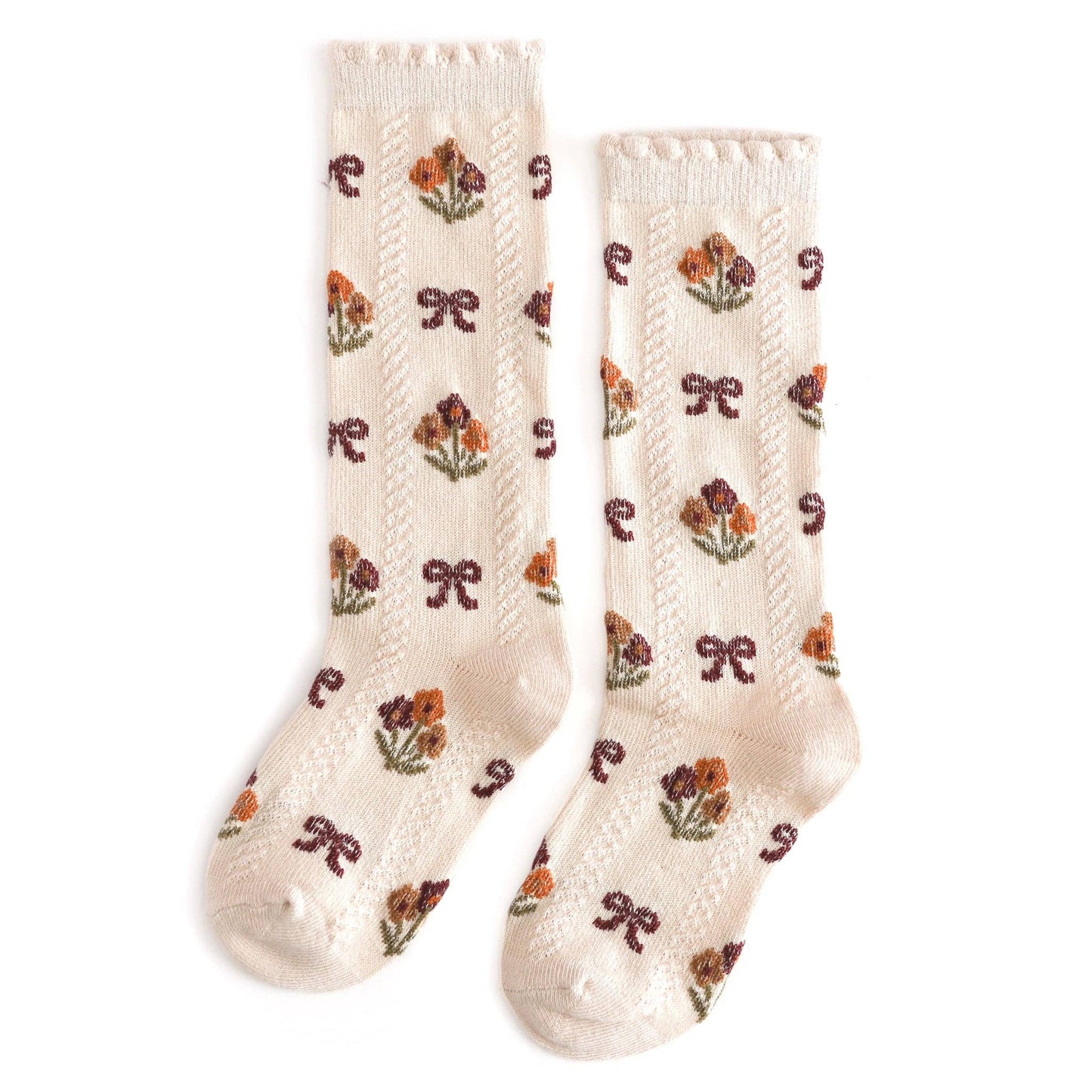 Pair of cream-colored socks with floral patterns on a white background