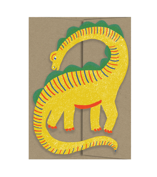 Colorful cutout dinosaur illustrated card on a brown envelope