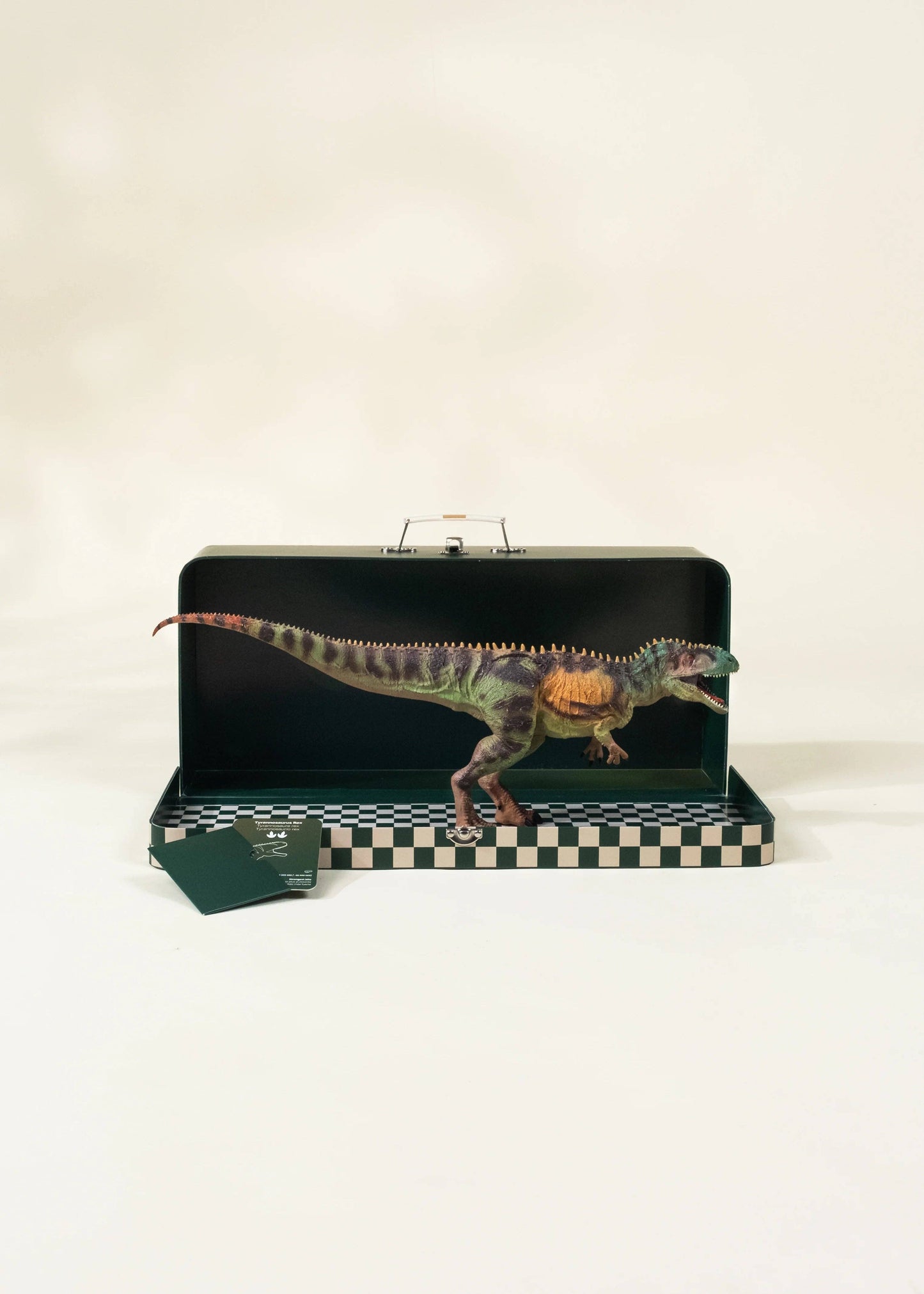 Dinosaur model inside a black case with a checkered base on a white background