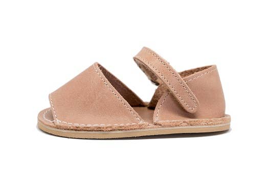 Tan sandal with a strap on a white background