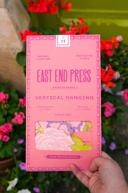 Pink packaging of East End Press vertical hanging with floral background