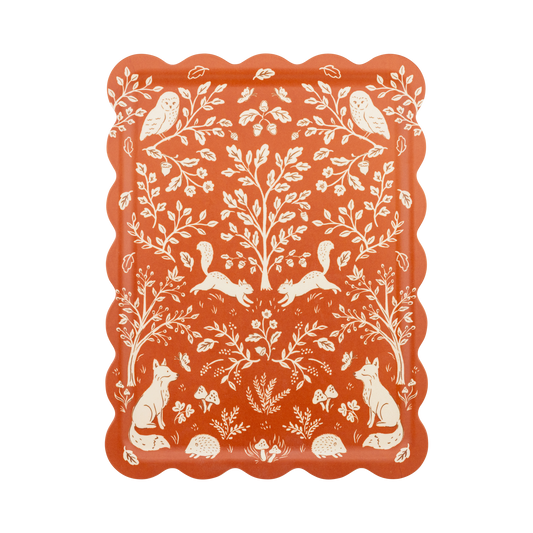 Decorative plate with white animal and nature pattern on a red background