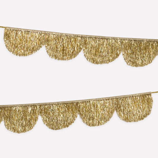 Gold tinsel fringe garland on a white background