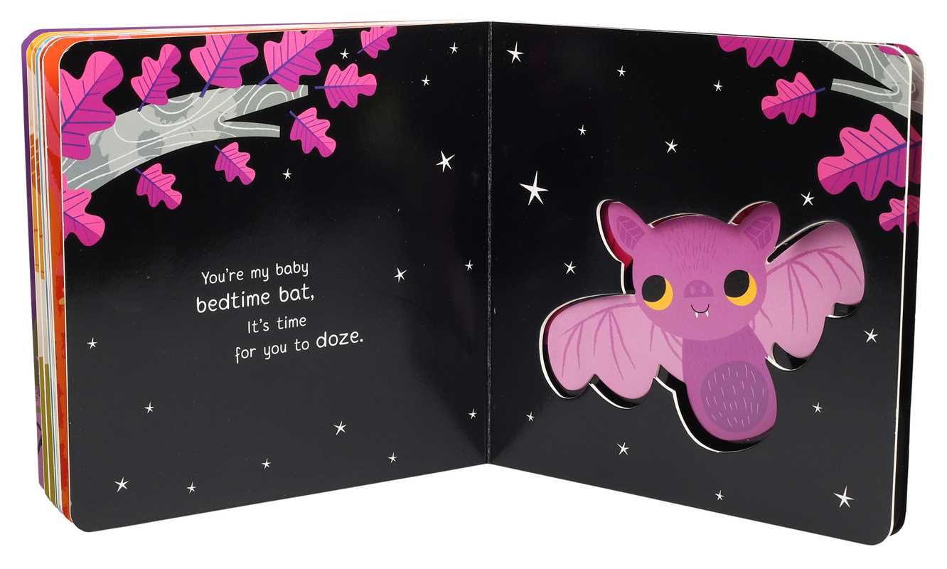 Open book with a purple bat illustration and text on a black background with pink flowers.
