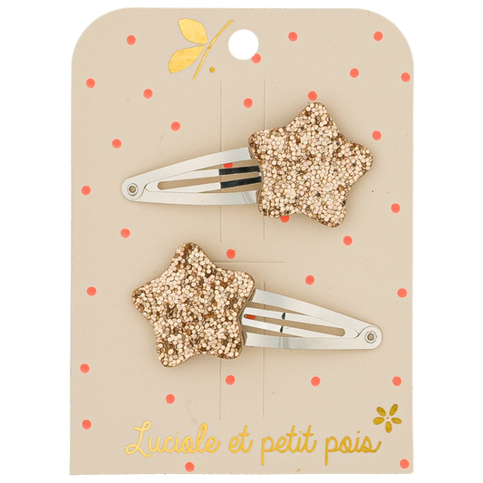 Two star-shaped hair clips on a beige card with red polka dots and floral designs, featuring the brand 'Lucile et petit pois'.