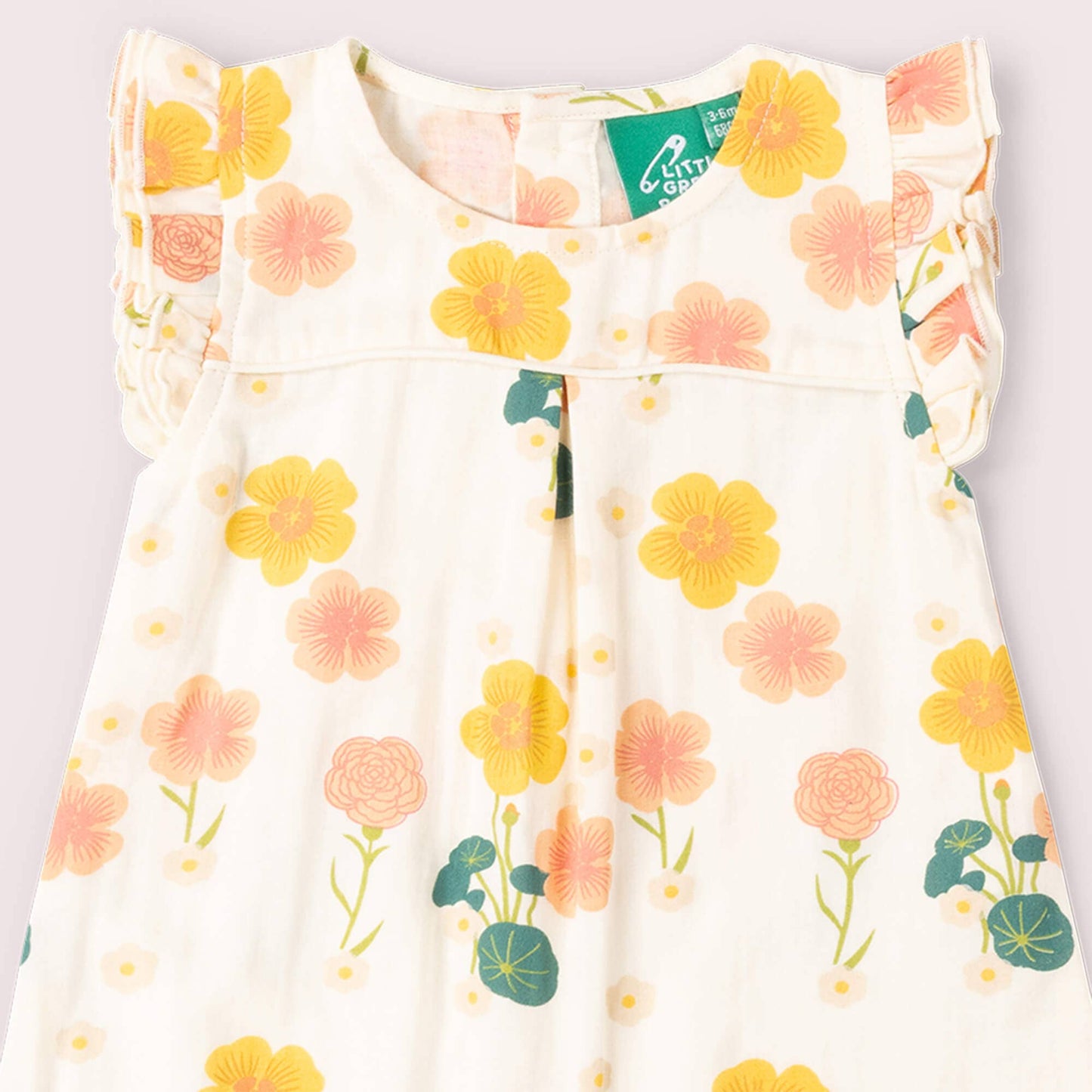 Floral-patterned dress with a visible brand tag on a light background