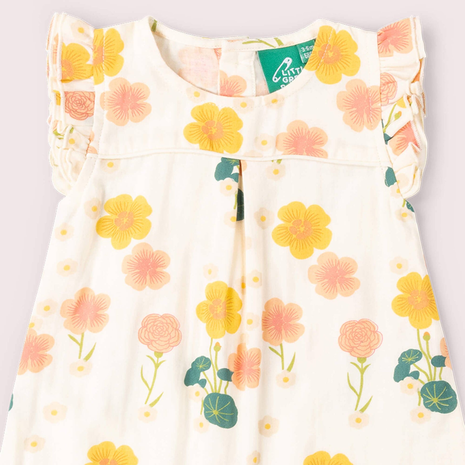 Floral-patterned dress with a visible brand tag on a light background