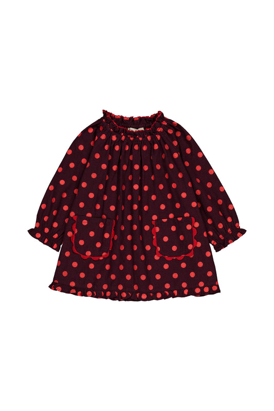 Baby dress in maroon with red dots and two front pockets, all on a white background