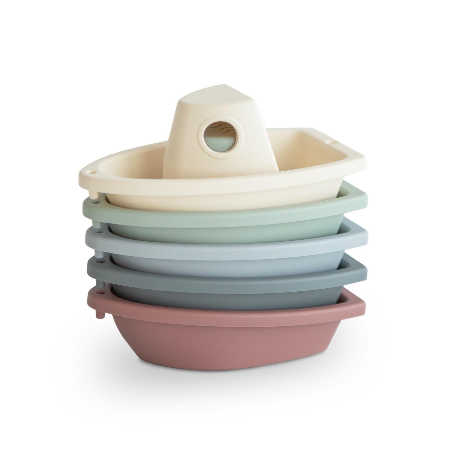 Stack of colorful plastic toy boats on a white background