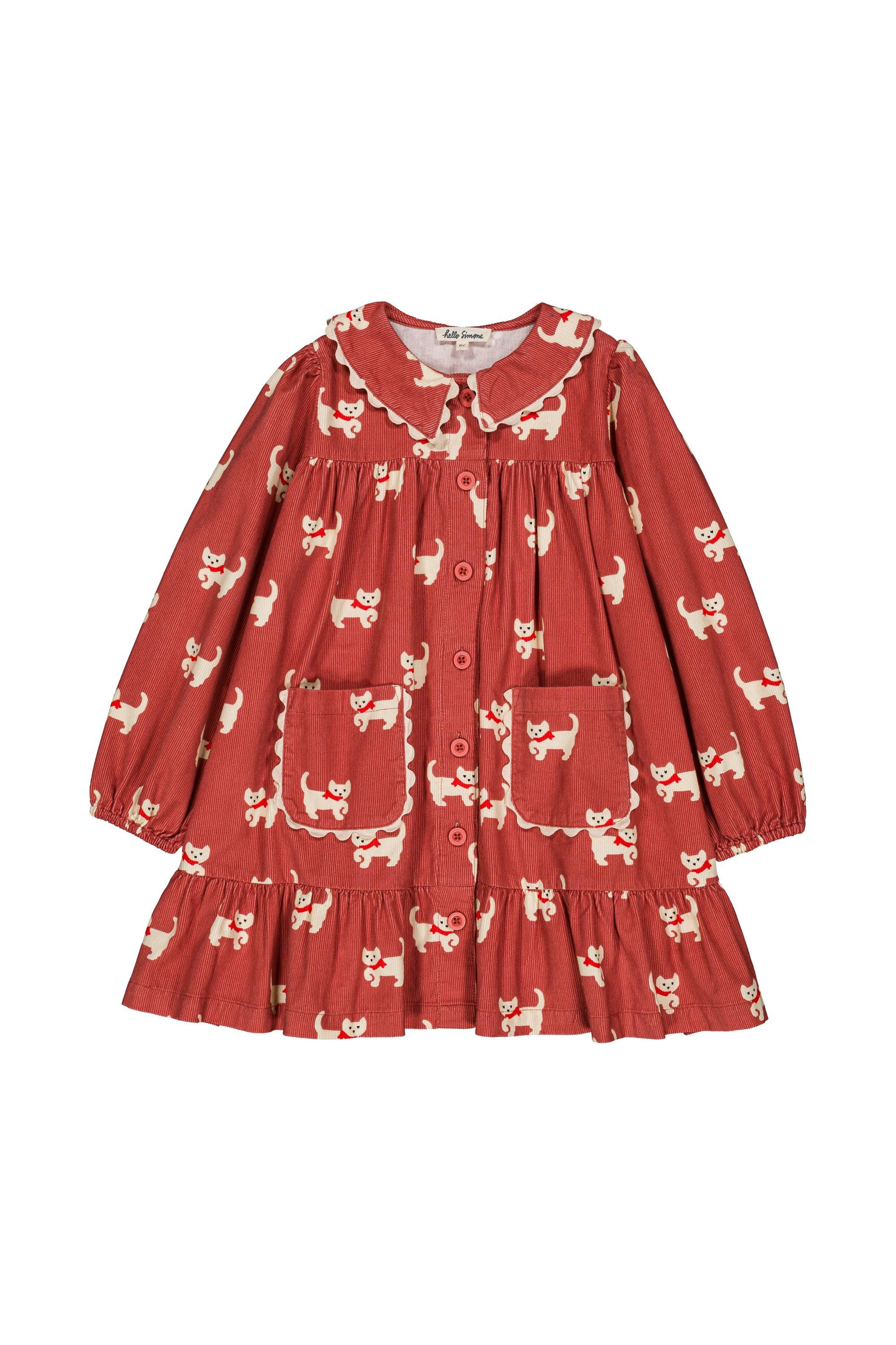 A toddler's long-sleeve button-up dress in a rust red fabric with a white cat print, featuring a Peter Pan collar, ruffled trim, and front pockets.