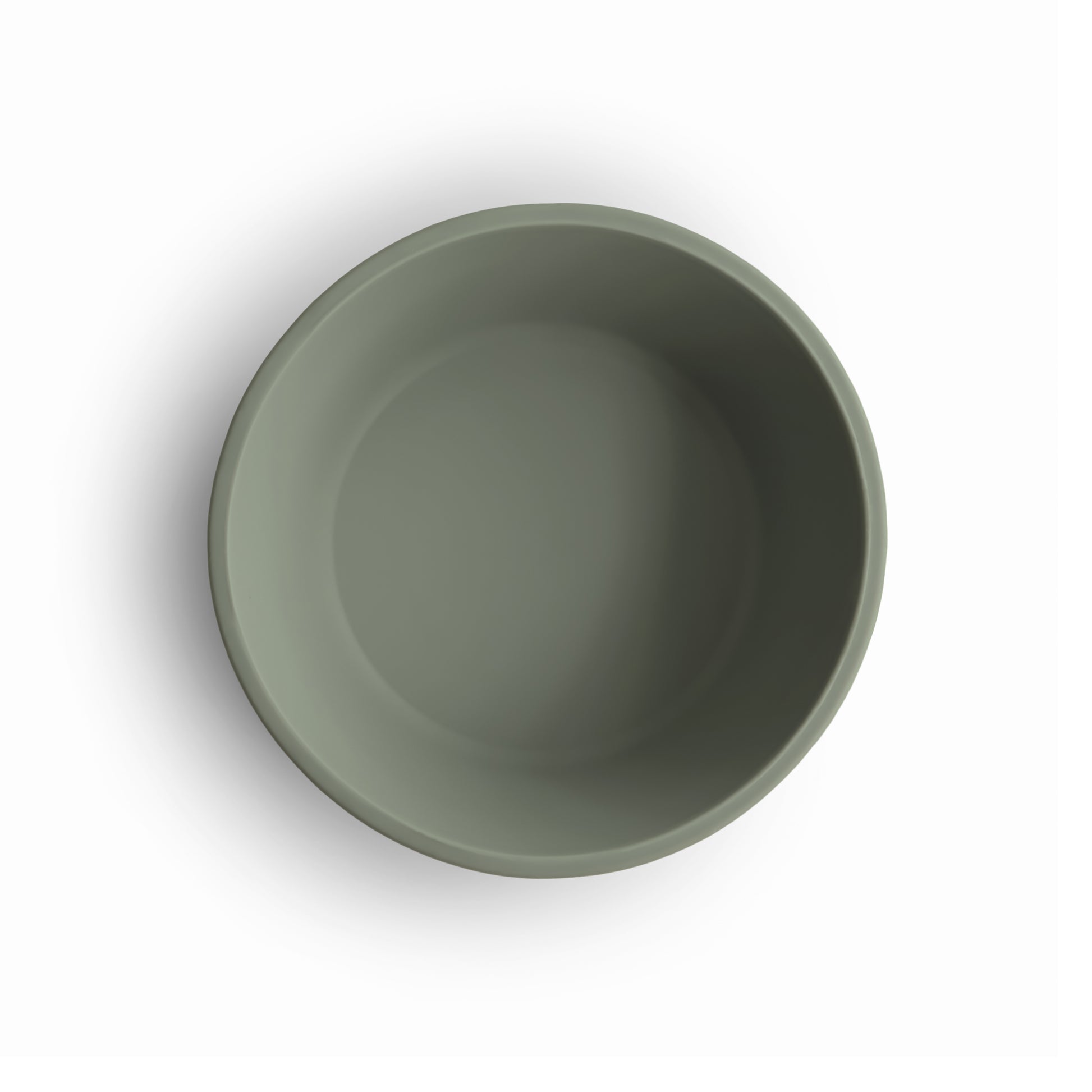Green silicone suction bowl top view on a white background