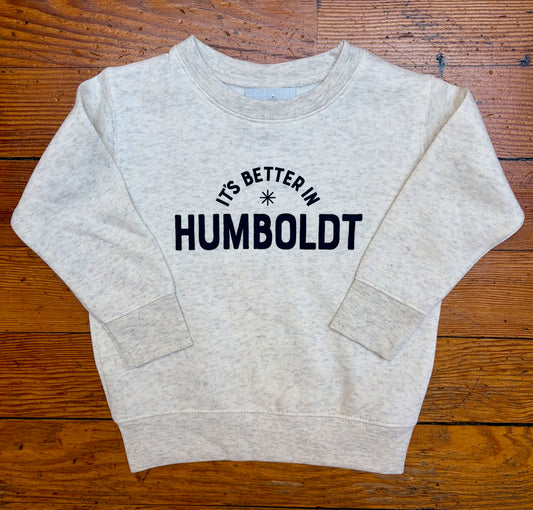 Gray sweatshirt with 'It's Better in Humboldt' text on a wooden surface