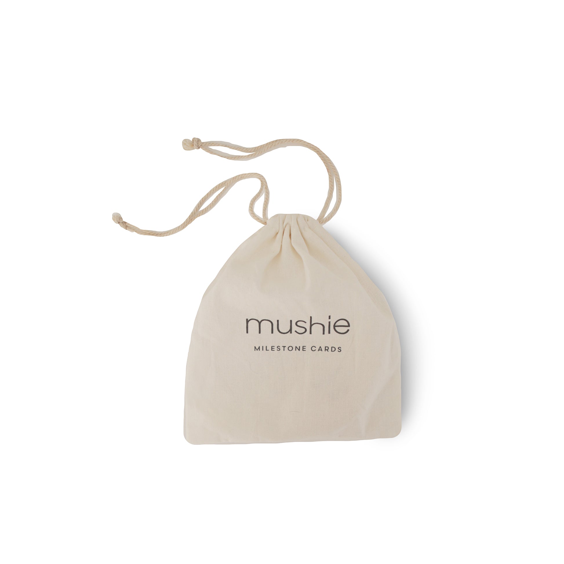 Beige drawstring bag with 'mushie' branding on a white background