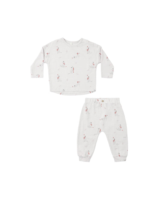 A two-piece baby clothing set featuring a long-sleeve top and matching pants in an off-white fabric with a dalmation print, displayed on a solid white background.