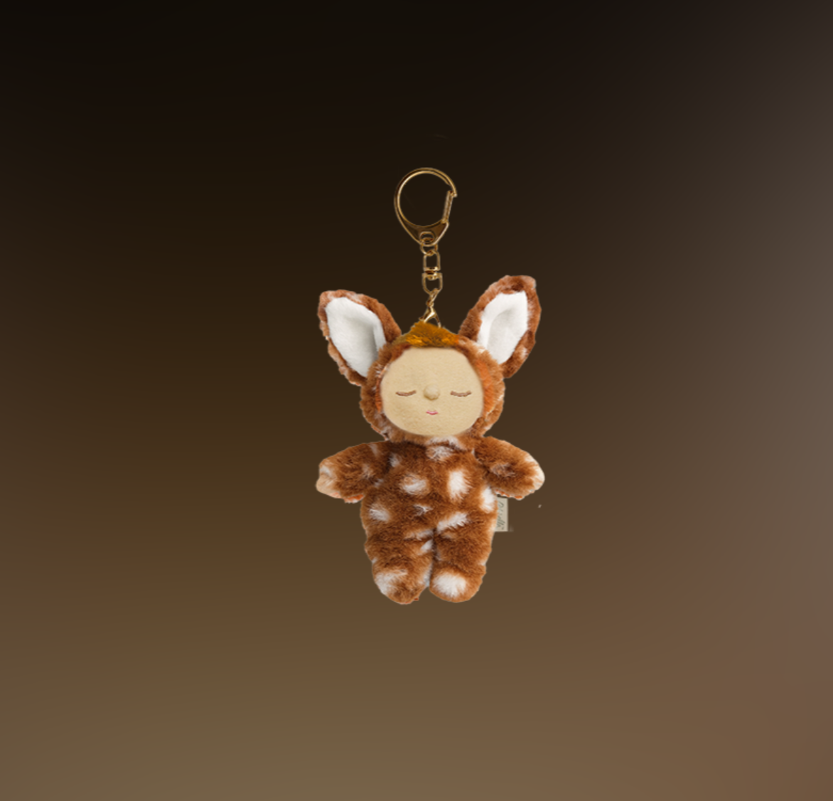 Plush keychain shaped like a deer on a gradient brown background