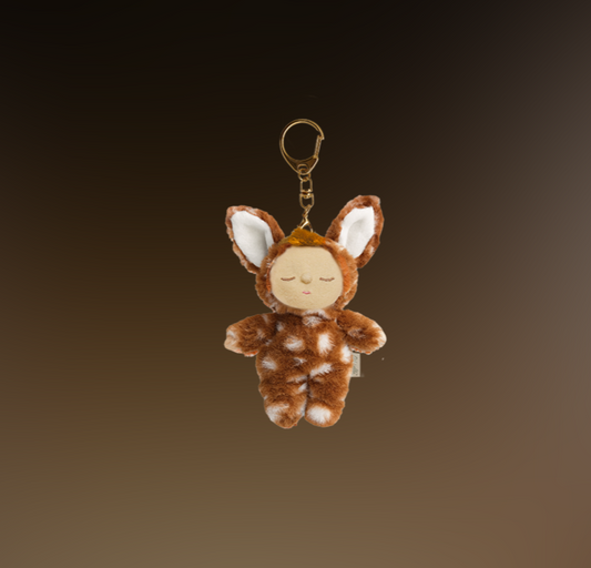 Plush keychain shaped like a deer on a gradient brown background