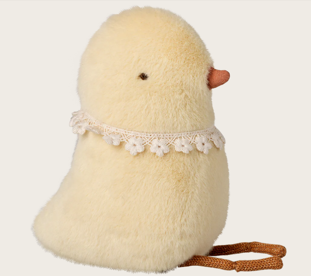 Plush chick toy with lace collar on a white background
