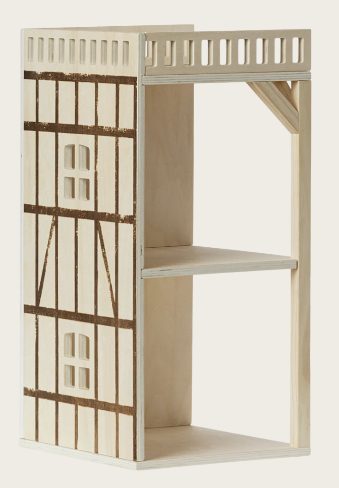 Two story wooden dollhouse on a white background