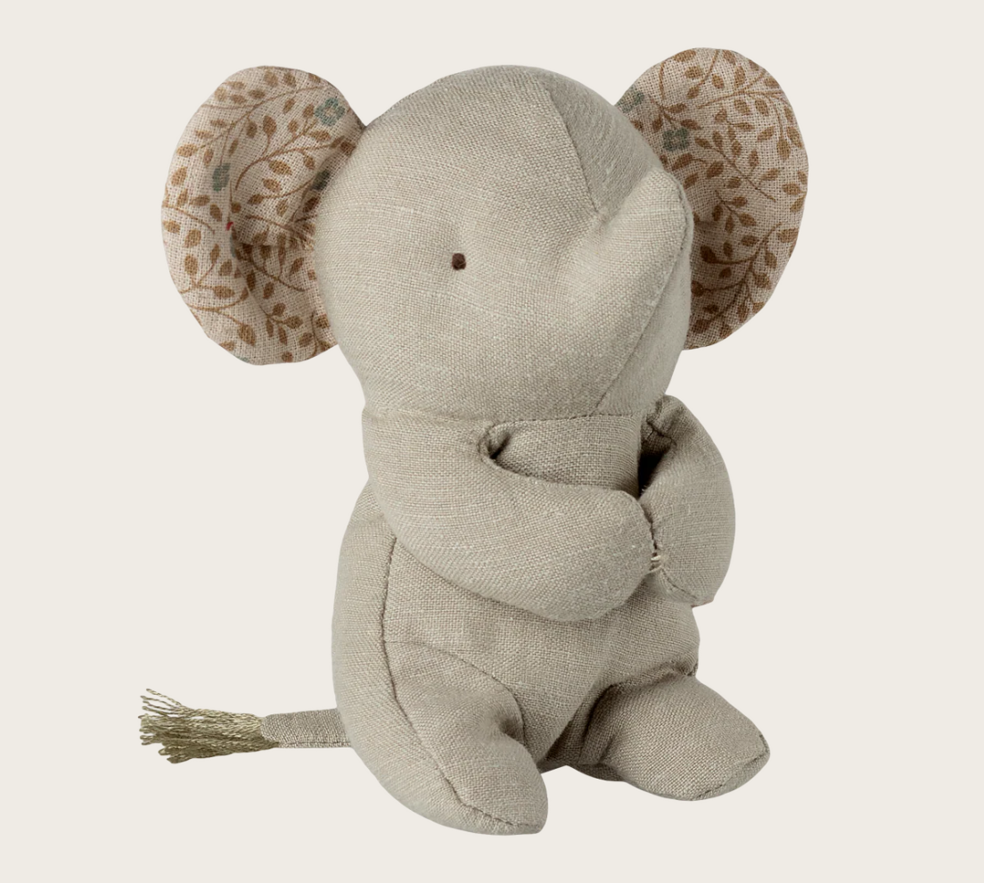 Textured elephant plush toy with floral ear accents on a light background
