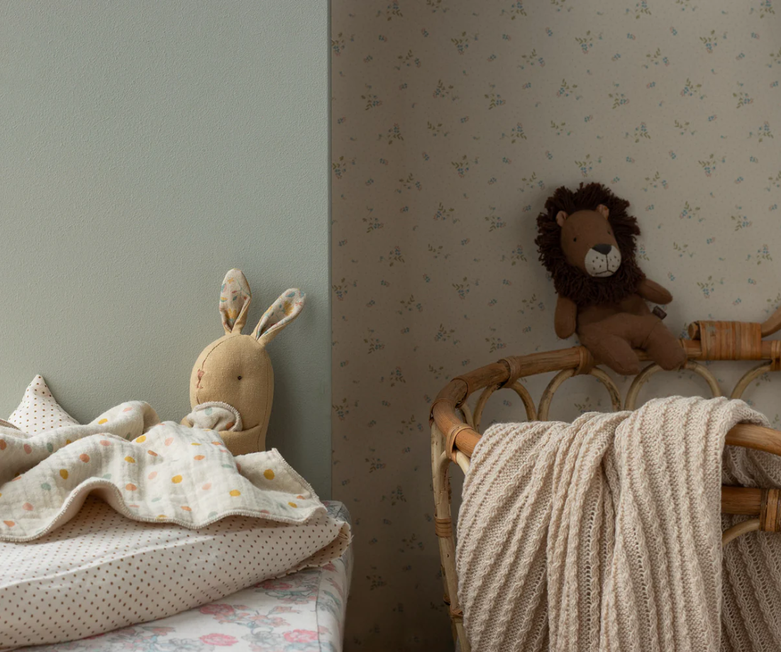 Children's room with stuffed animal toys on a bed and chair.