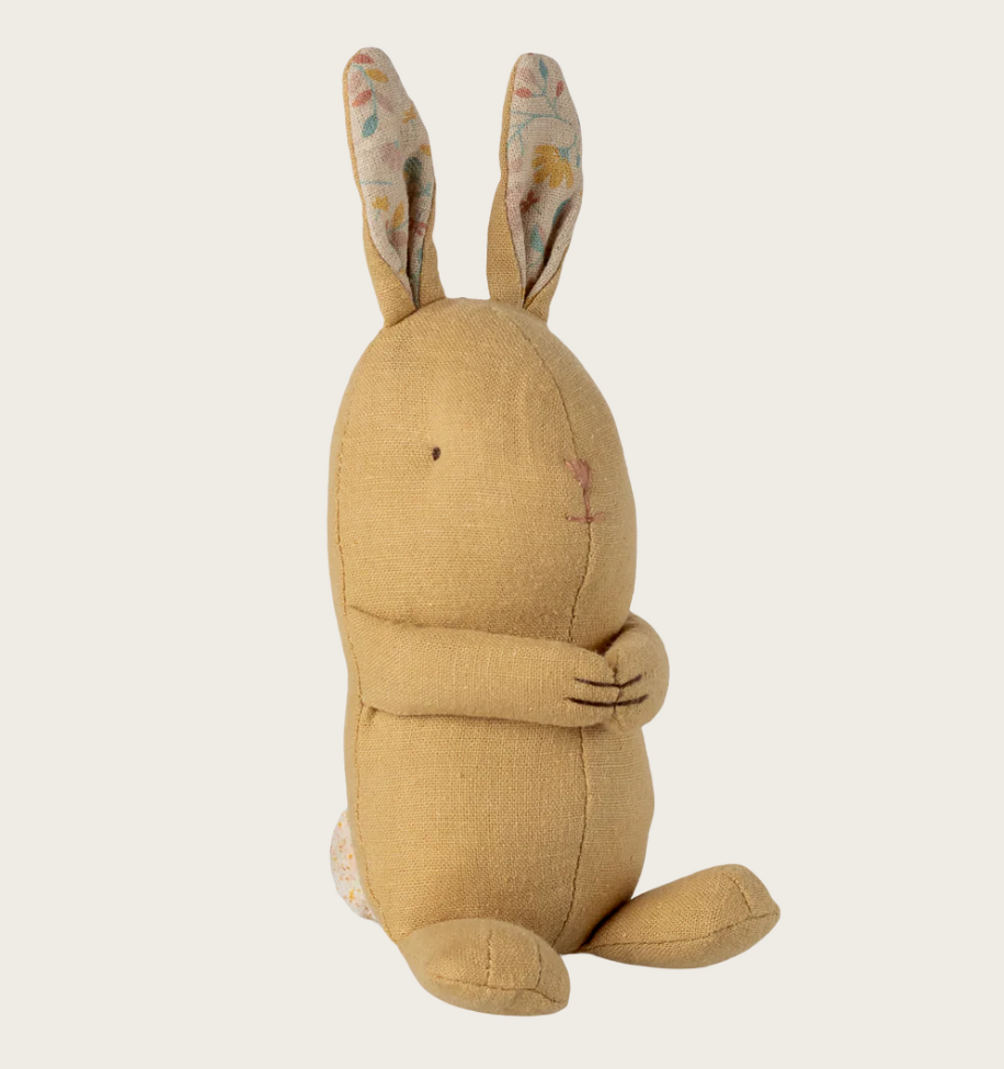 Yellow plush rabbit toy on a white background
