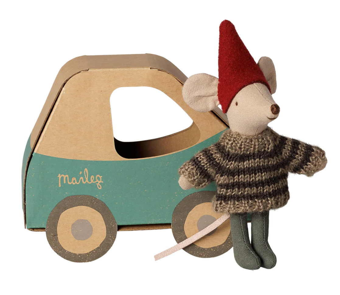 Maileg little brother mouse with red elf hat and striped brown sweater next to a cardboard toy car