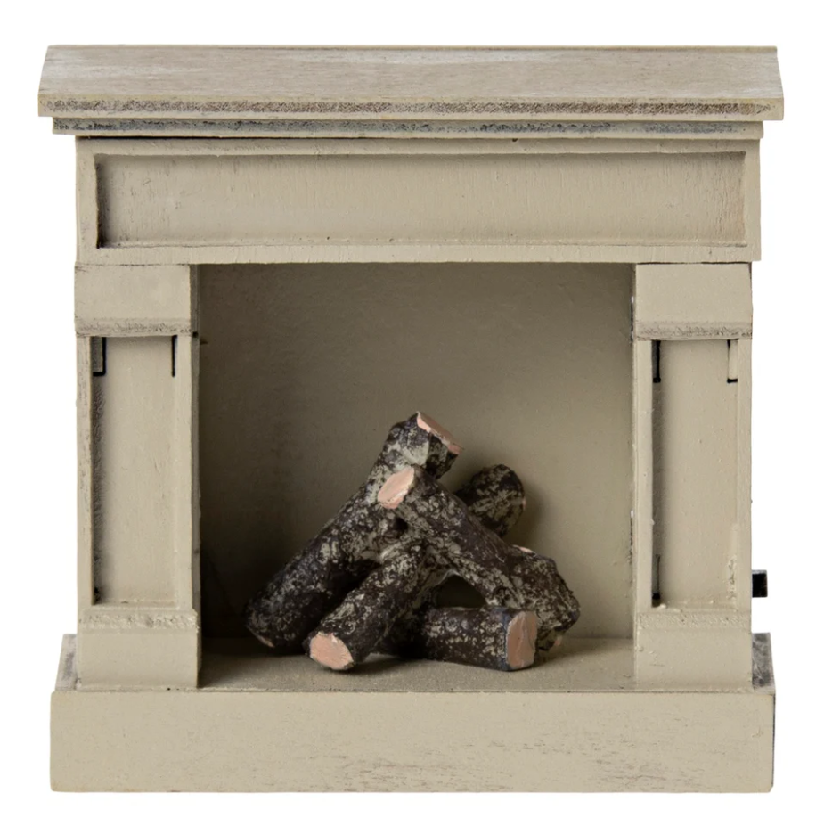 Toy wooden fireplace with logs on a white background