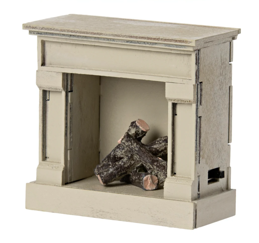 Toy wooden fireplace with logs on a white background